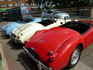 MGA 60th Anniversary this year. garage cars back